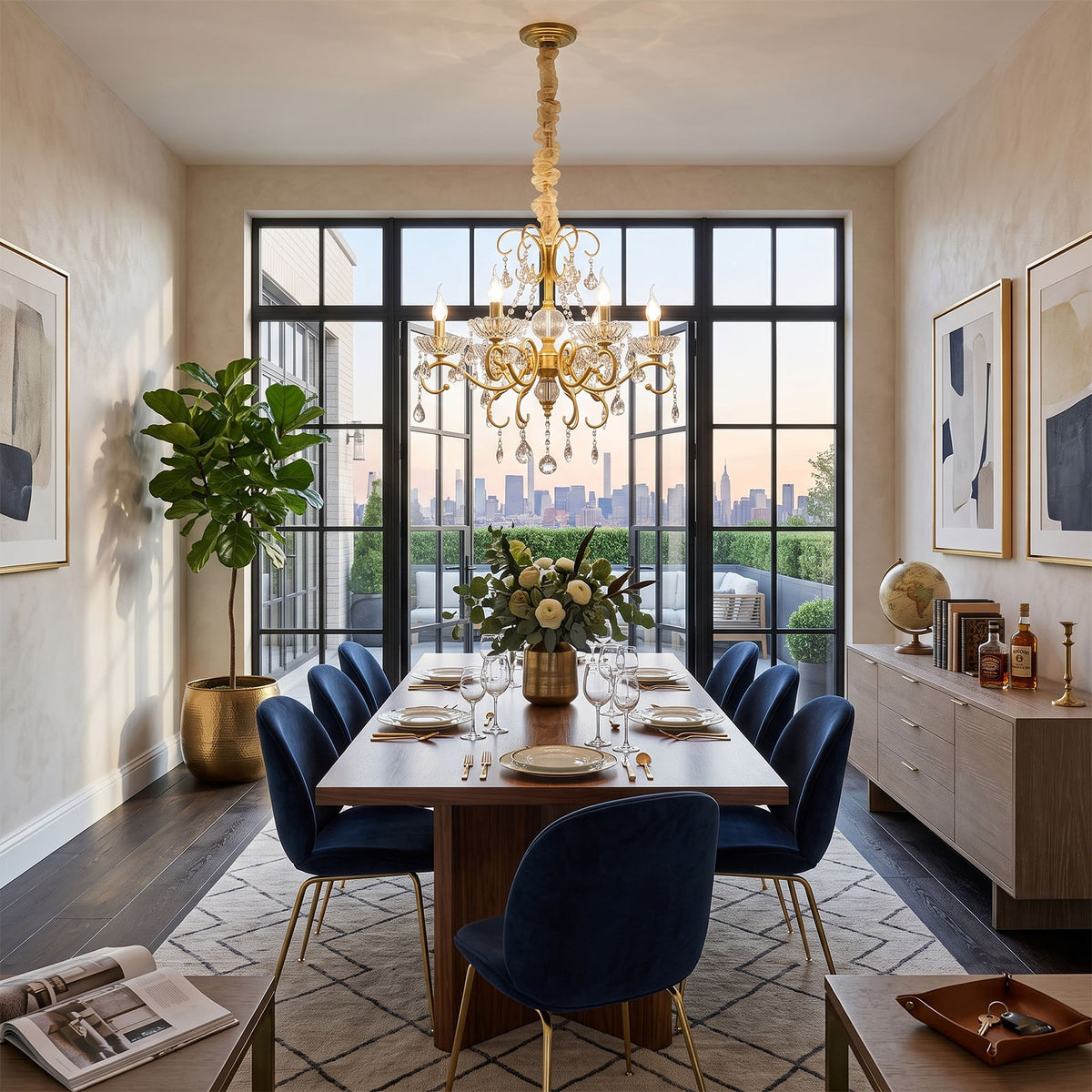 Torvald Scrolled Crystal Brass Chandelier | Cut Crystal and Brass | Hanging in a luxury dining room with blue velvet chairs and large windows | Severn Lighting