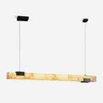 Vale Alabaster Linear Glow Pendant Lighting | Natural Alabaster and Black Metal | Full studio front view isolated on a white background showing the lit linear alabaster shade with black brackets | Severn Lighting