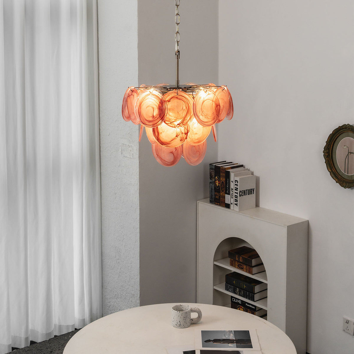 Vaucelle Swirled Glass Disc Tiered Chandelier | Swirled Glass and Brass | Hanging in a modern room near a decorative fireplace ledge | Severn Lighting