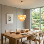 Vaucelle Swirled Glass Disc Tiered Chandelier | Swirled Glass and Brass | Suspended over a long wooden table in a bright dining room | Severn Lighting
