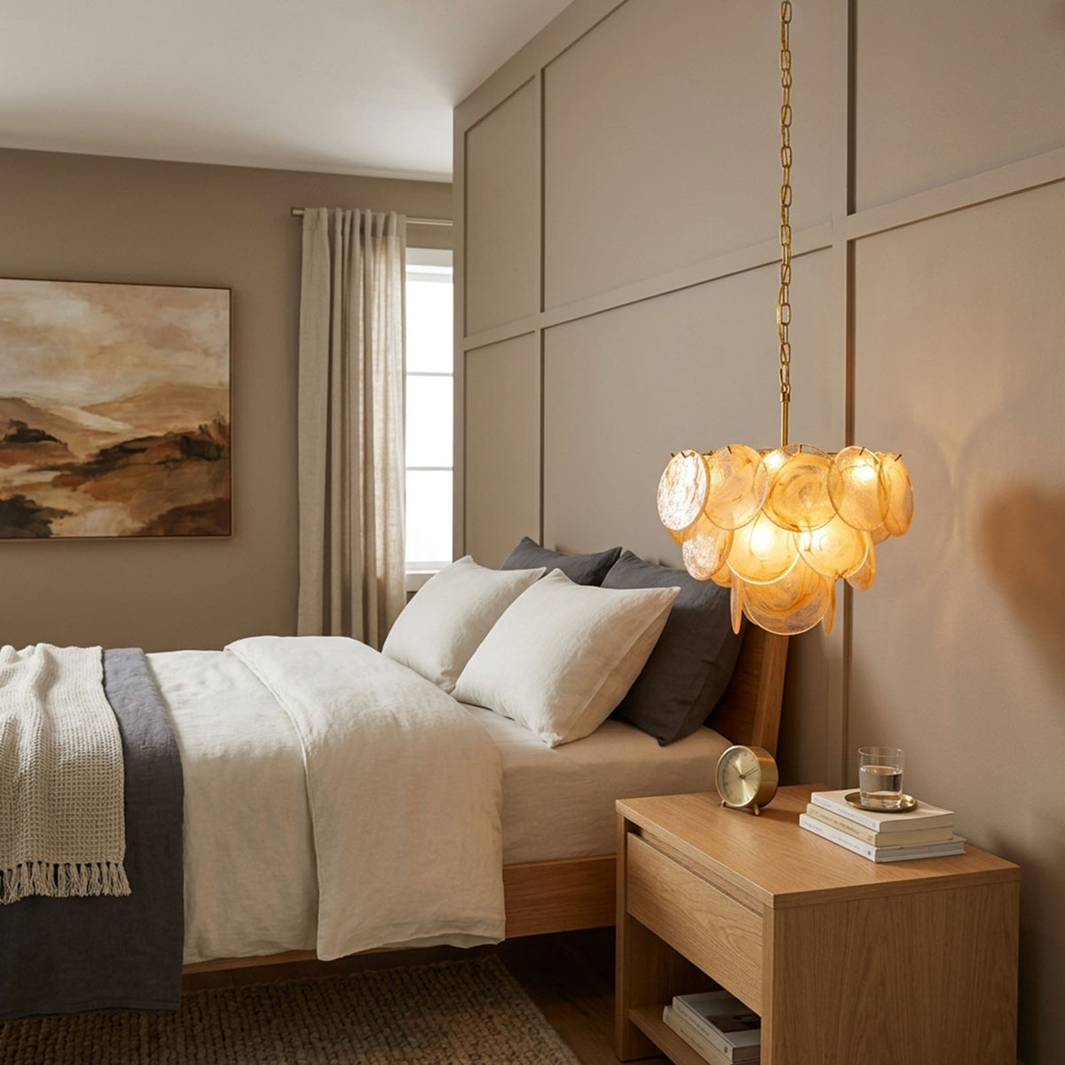 Vaucelle Swirled Glass Disc Tiered Chandelier | Swirled Glass and Brass | Centered in a bedroom above nightstands with soft ambient light | Severn Lighting