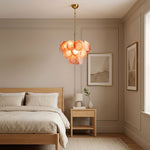 Vaucelle Swirled Glass Disc Tiered Chandelier | Swirled Glass and Brass | Hanging in a cozy bedroom with wooden bed and bedside tables | Severn Lighting