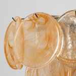 Vaucelle Swirled Glass Disc Tiered Chandelier | Swirled Glass and Brass | Reddish-orange swirled glass variant illuminated on neutral backdrop | Severn Lighting