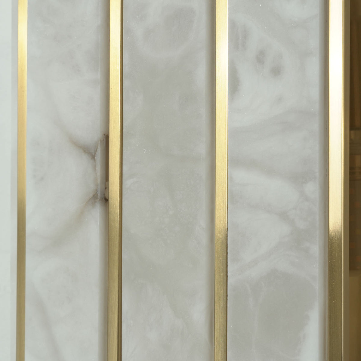 Veraune Bar Wall Sconce | Natural Carved Alabaster | Macro detail of mineral stone veining and brass bar | Severn Lighting
