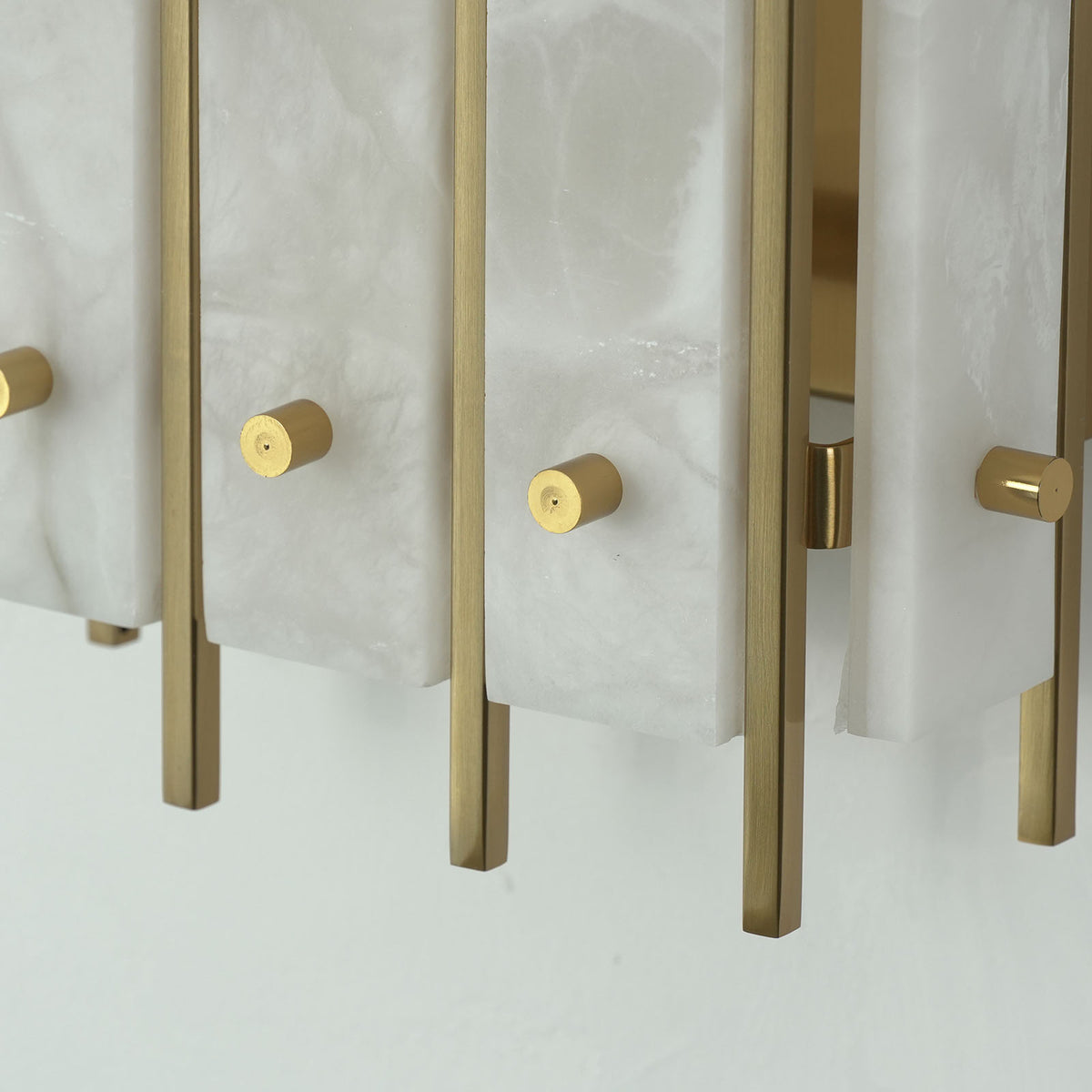 Veraune Bar Wall Sconce | Solid Brass Hardware | Close-up of bottom brass bars and round fixing screw caps | Severn Lighting
