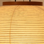 Verena Ribbed Paper Column Floor Lamp | Ribbed Paper and Metal Tripod Legs | Horizontal close-up pattern shot of the finely crafted ribbed lines on the illuminated paper shade | Severn Lighting