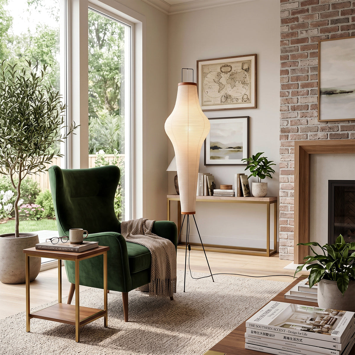Verena Ribbed Paper Column Floor Lamp | Ribbed Paper and Metal Tripod Legs | Styling a bright living space beside a luxurious green velvet armchair and a wooden fireplace mantel | Severn Lighting