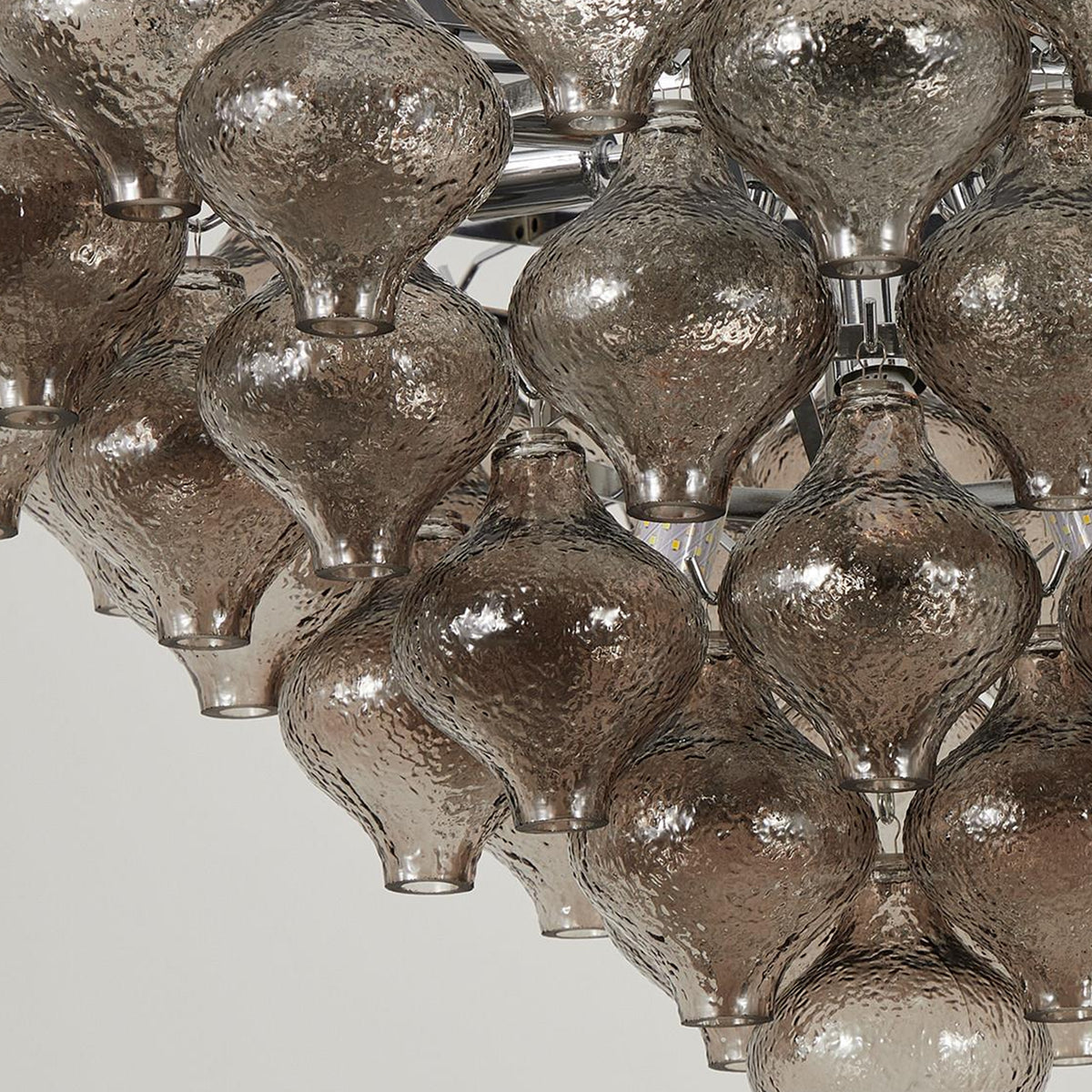 Vespera Tiered Smoked Glass Chandelier | Textured Smoked Glass | Detailed macro perspective focusing on the unlit textured glass drop components and hooks | Severn Lighting