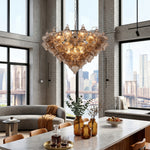 Vespera Tiered Smoked Glass Chandelier | Textured Smoked Glass | Suspended in a bright high-ceiling living area with a panoramic city bridge window view | Severn Lighting