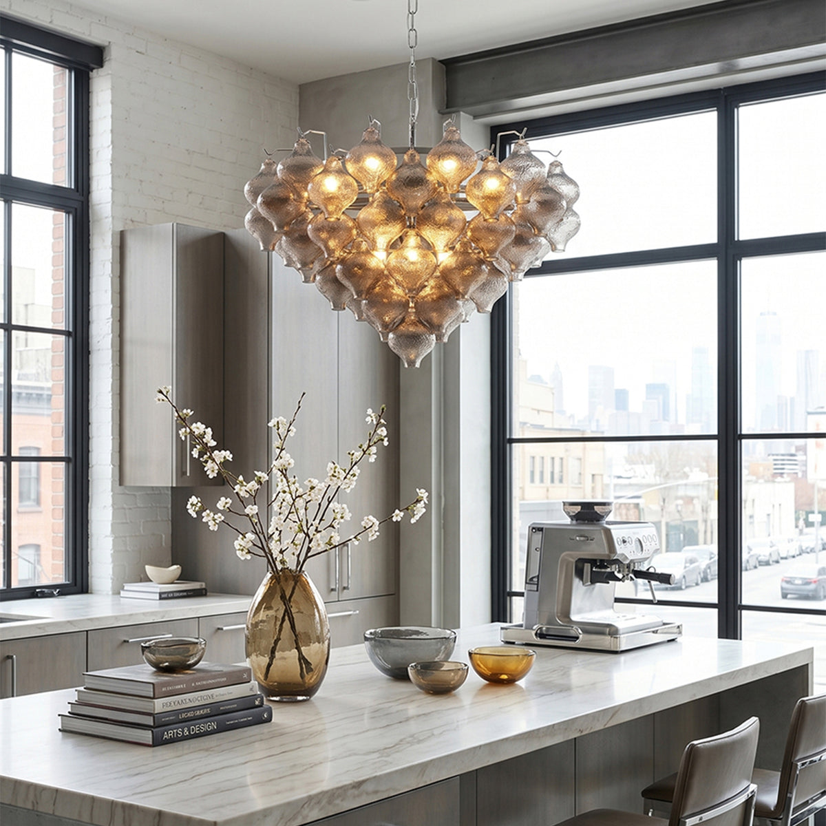 Vespera Tiered Smoked Glass Chandelier | Textured Smoked Glass | Styled over a sleek white marble kitchen counter with large industrial loft windows | Severn Lighting