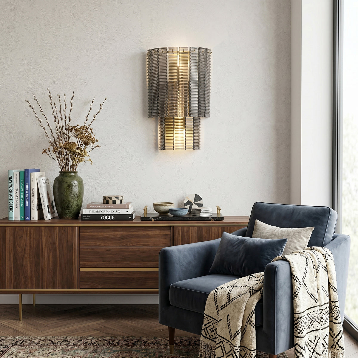 Vespera Tiered Smoky Glass Wall Lamp | Glass, Metal | Mounted as elegant accent lighting on a grey feature wall above a mid-century wooden sideboard cabinet with a blue armchair nearby | Severn Lighting