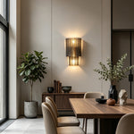 Vespera Tiered Smoky Glass Wall Lamp | Glass, Metal | Casting a warm ambient glow on a wall in a sophisticated contemporary dining room next to a long wooden dining table | Severn Lighting
