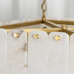 Vivienne Tiered Alabaster Chandelier | Alabaster, Brass | Close-up focus on the gold brass frame pins securing the vertical translucent white alabaster stone plates | Detail shot | Severn Lighting