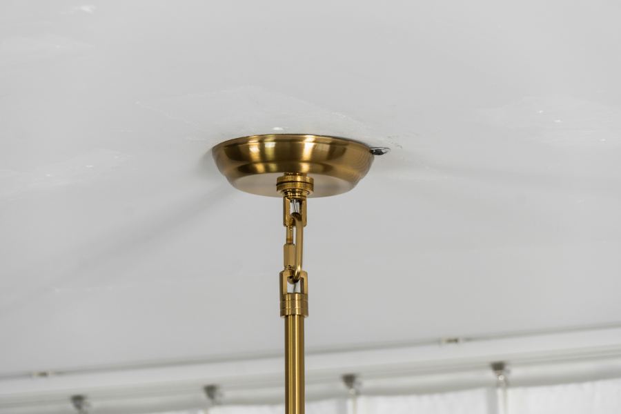 Brass canopy with a linked swivel joint above a downrod