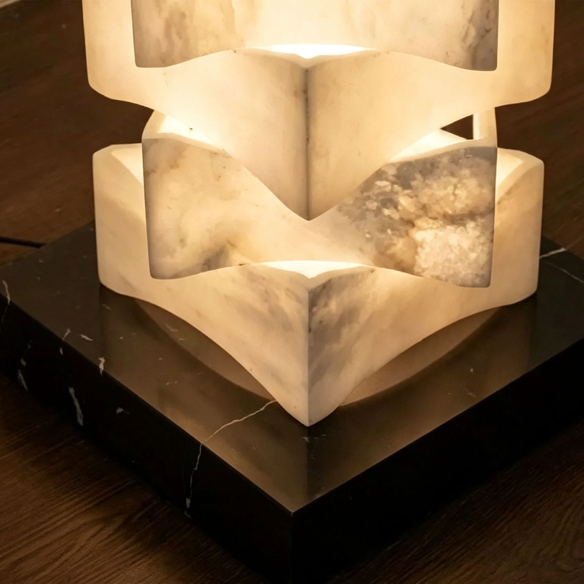 Alden Interlocking Alabaster Column Floor Lamp | Natural Alabaster and Metal | Macro detail shot of the dark square base and lower alabaster column | Severn Lighting