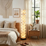 Alden Interlocking Alabaster Column Floor Lamp | Natural Alabaster and Metal | Standing beside a bed in a warm cozy bedroom setting | Severn Lighting