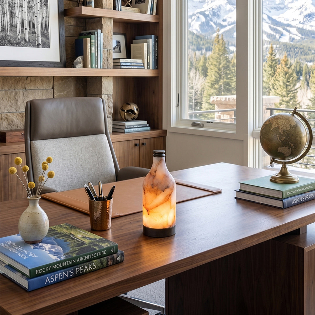 Aldric Alabaster Flask Table Lamp | Natural Alabaster Stone and Bronze Metal | Styled on a wooden executive desk in a home office study with large windows looking out at mountains | Severn Lighting