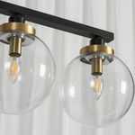 Alistair Linear Glass Globe Chandelier | Clear Glass Detail | Close-up unlit view of the clear glass globe shades highlighting the premium gold brass sockets and internal filament bulbs | Detail shot | Severn Lighting