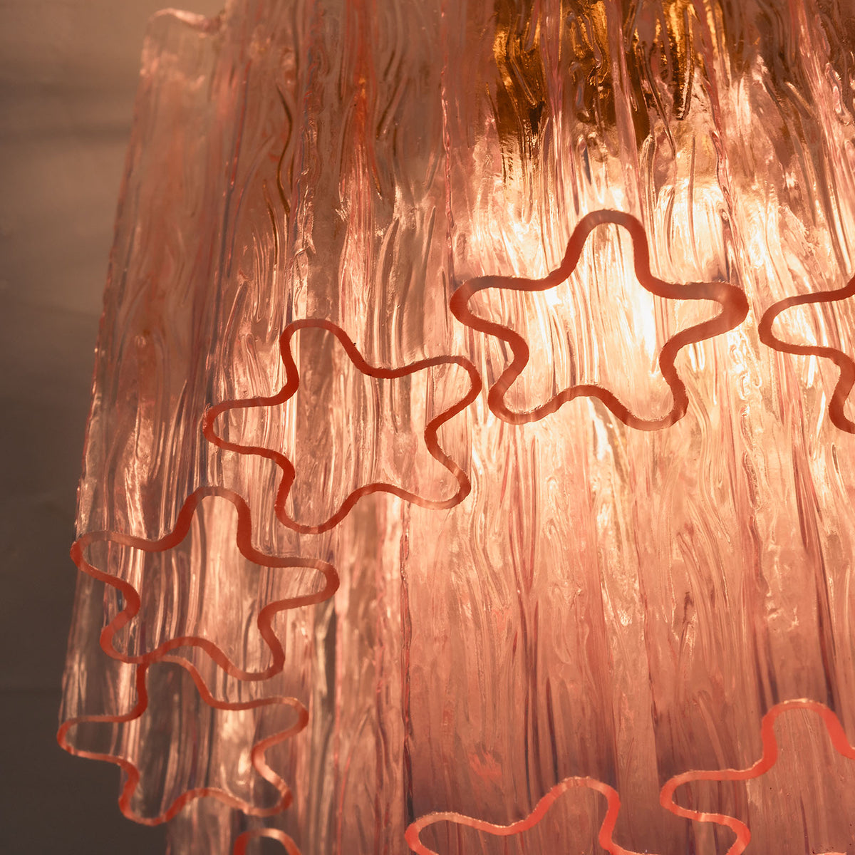 Amabel Dazzling Pink Glass Ceiling Light | Pink Glass and Brass | Close-up view of the glowing translucent pink starburst glass tubes | Severn Lighting