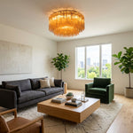 Ambleve Amber Glass Tube Flush Mount Chandelier | Fluted Amber Glass and Brass | Displayed in a contemporary living room with black couch and coffee table | Severn Lighting