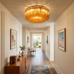 Ambleve Amber Glass Tube Flush Mount Chandelier | Fluted Amber Glass and Brass | Illuminating a hallway corridor with a wooden console table | Severn Lighting