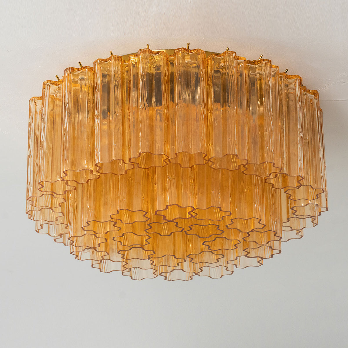 Ambleve Amber Glass Tube Flush Mount Chandelier | Fluted Amber Glass and Brass | Studio product view illuminated against a light grey background | Severn Lighting