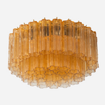 Ambleve Amber Glass Tube Flush Mount Chandelier | Fluted Amber Glass and Brass | Front full view on a pure white background, illuminated | Severn Lighting