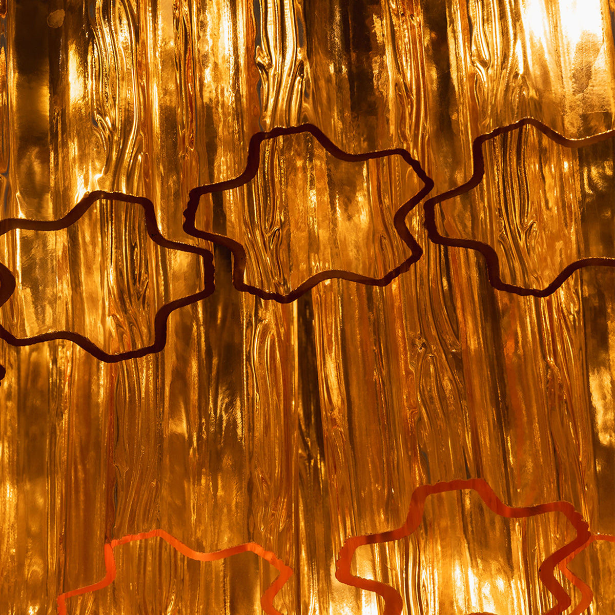 Ambleve Amber Glass Tube Flush Mount Chandelier | Fluted Amber Glass and Brass | Macro view of rippled amber glass texture and metal mounting wire | Severn Lighting