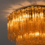 Ambleve Amber Glass Tube Flush Mount Chandelier | Fluted Amber Glass and Brass | Angled bottom view highlighting glowing amber glass tubes on ceiling | Severn Lighting
