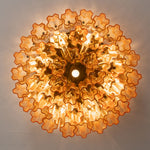 Ambleve Amber Glass Tube Flush Mount Chandelier | Fluted Amber Glass and Brass | Direct illuminated bottom-up view displaying glowing radial light pattern | Severn Lighting