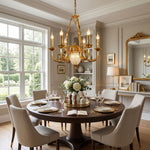 Anders Fluted Glass Urn Brass Chandelier | Fluted Glass and Brass | Suspended over a round wooden dining table in a bright dining room | Severn Lighting