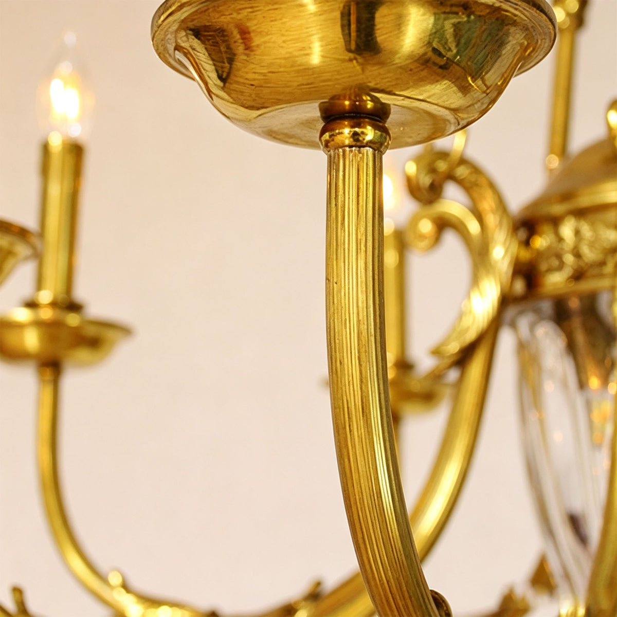 Anders Fluted Glass Urn Brass Chandelier | Fluted Glass and Brass | Close-up detail of the smooth curved brass scroll arm and candle socket | Severn Lighting