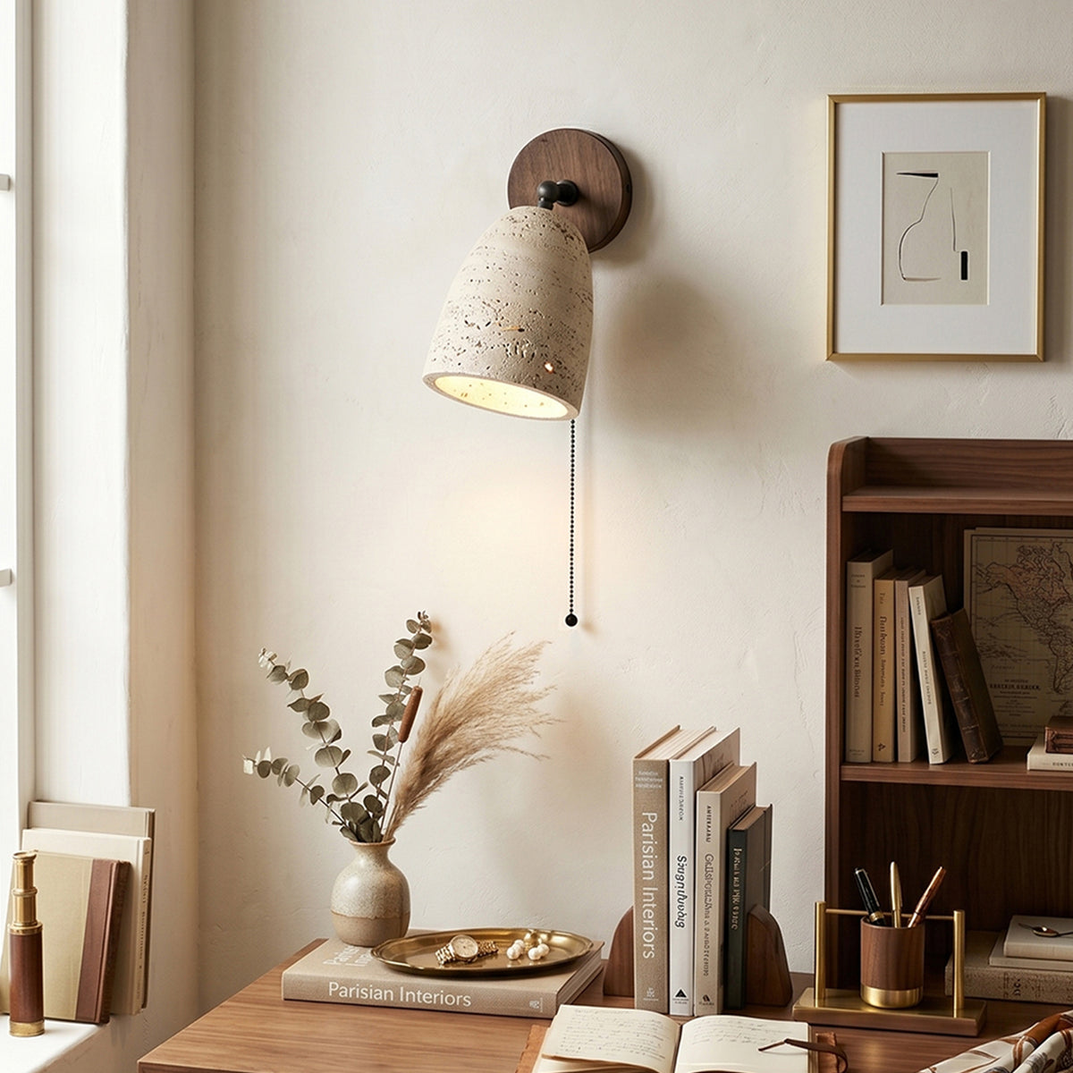 Aria Travertine Wood Wall Lamp | Travertine, Wood, Metal | Wall-mounted over a minimalist wooden executive writing desk with books and a vase in a bright workspace | Samu Lamp