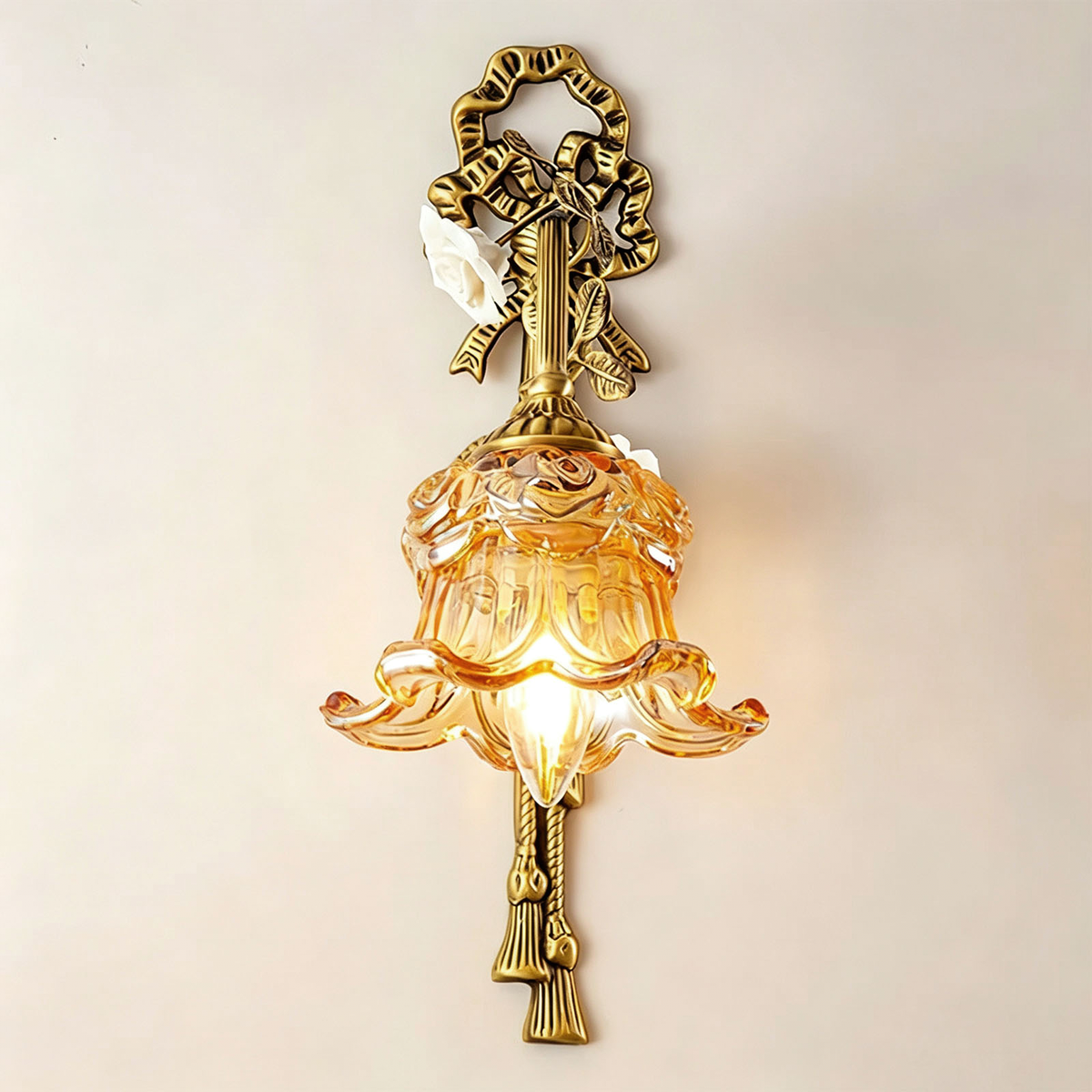 Armelle Rose Glass Brass Wall Lamp | Glass, Ceramic and Brass | Full view glowing brightly on a plain neutral background | Severn Lighting