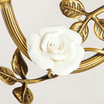 Armelle Rose Glass Brass Wall Lamp | Glass, Ceramic and Brass | Detail shot highlighting the white porcelain rose flower and brass leaves | Severn Lighting