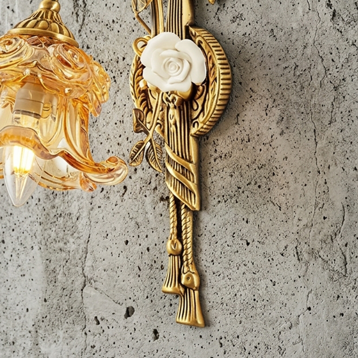Armelle Rose Glass Brass Wall Lamp | Glass, Ceramic and Brass | Mounted on a concrete grey wall showing the white rose element | Severn Lighting