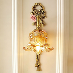 Armelle Rose Glass Brass Wall Lamp | Glass, Ceramic and Brass | Front view illuminated warmly on a white wall panel | Severn Lighting