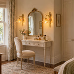 Armelle Rose Glass Brass Wall Lamp | Glass, Ceramic and Brass | Mounted on a wall beside a vintage vanity mirror and dressing table | Severn Lighting