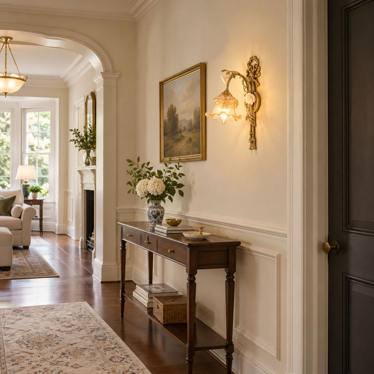 Armelle Rose Glass Brass Wall Lamp | Glass, Ceramic and Brass | Illuminating a hallway corridor above a wooden console table | Severn Lighting