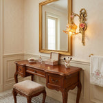 Armelle Rose Glass Brass Wall Lamp | Glass, Ceramic and Brass | Styled beside an antique wooden vanity table and mirror | Severn Lighting