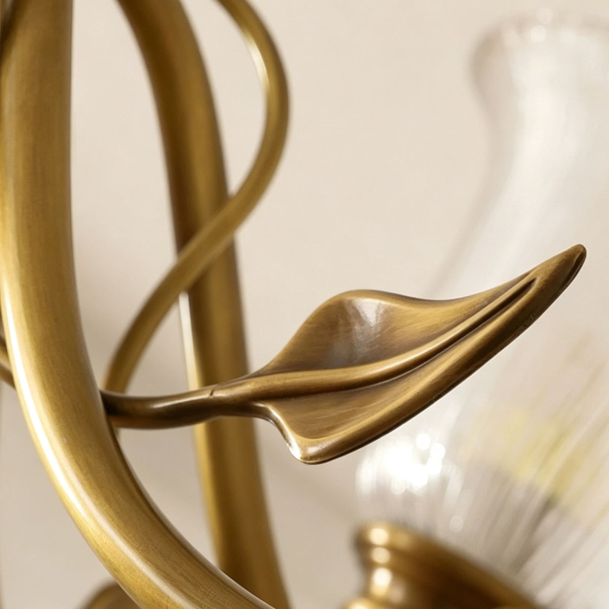 Auberon Ribbed Glass Vine Brass Chandelier | Ribbed Glass and Brass | Macro detail shot of the sculpted brass leaf ornament on the curving arm | Severn Lighting