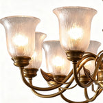 Auberon Ribbed Glass Vine Brass Chandelier | Ribbed Glass and Brass | Medium close-up highlighting the glowing ribbed glass shades and brass arms | Severn Lighting