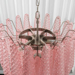 Aubine Pink Textured Glass Tiered Chandelier | Pink Textured Glass and Brass | Top-down angled view of internal brass frame with pink glass prisms | Severn Lighting