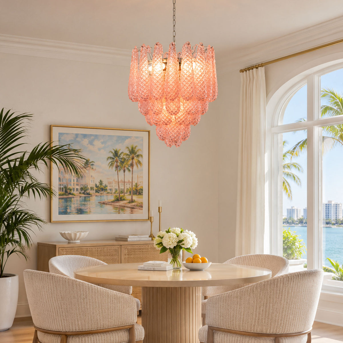 Aubine Pink Textured Glass Tiered Chandelier | Pink Textured Glass and Brass | Illuminating a bright dining area with round marble table and arched windows | Severn Lighting