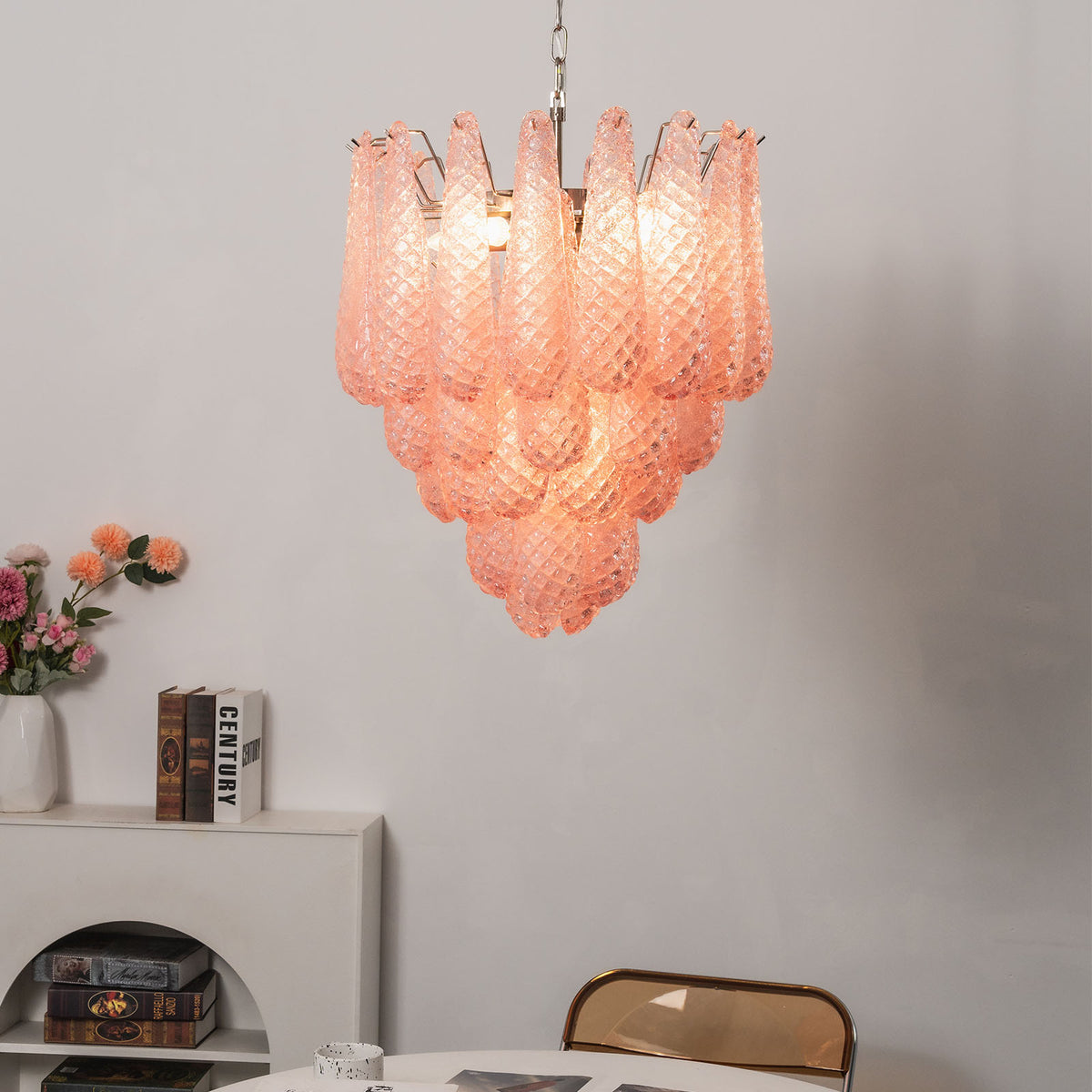 Aubine Pink Textured Glass Tiered Chandelier | Pink Textured Glass and Brass | Real-life view hanging above a round dining table near a white fireplace | Severn Lighting