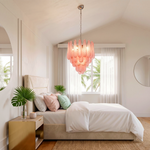 Aubine Pink Textured Glass Tiered Chandelier | Pink Textured Glass and Brass | Positioned in a sloped ceiling attic bedroom with warm lighting | Severn Lighting