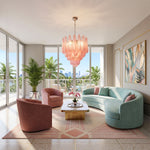 Aubine Pink Textured Glass Tiered Chandelier | Pink Textured Glass and Brass | Centered in a luxury living room with curved sofa and bay windows | Severn Lighting