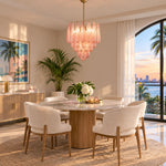 Aubine Pink Textured Glass Tiered Chandelier | Pink Textured Glass and Brass | Displayed in an elegant dining room over a round table with sunset views | Severn Lighting