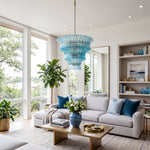 Azura Aquamarine Cascading Glass Chandelier | Glass, Metal | Providing a cozy colorful glow in a contemporary living space decorated with white couches, blue accent pillows, and built-in bookcases | Severn Lighting