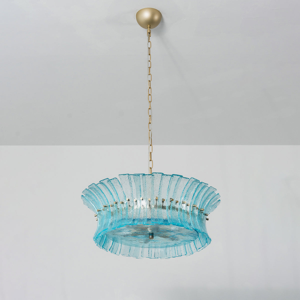 Azura Aquamarine Cascading Glass Chandelier | Glass, Metal | Studio view of a shorter single-tier variant featuring a wide ring of textured blue glass panels suspended by a gold chain | Severn Lighting